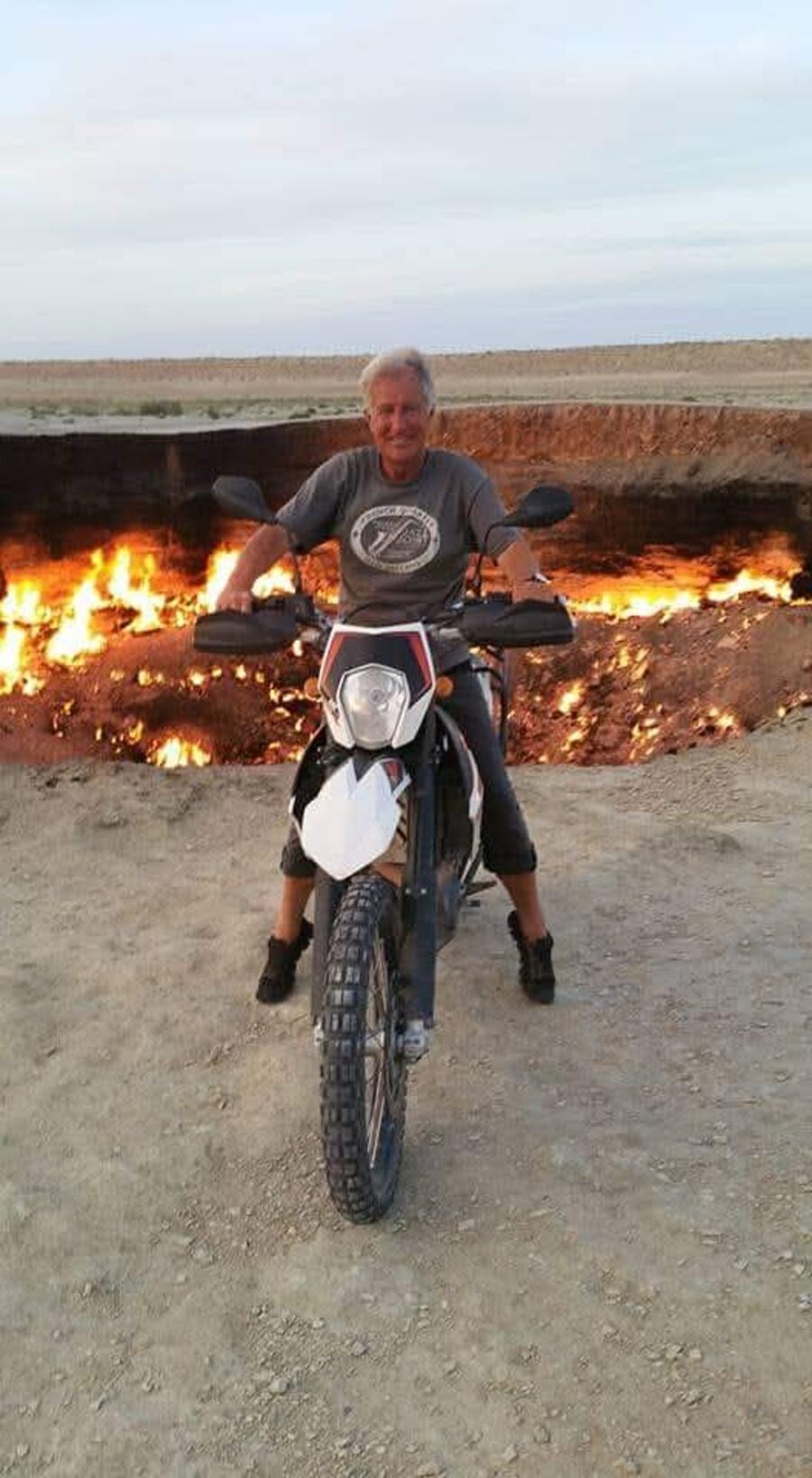 Kurt Hannig auf seinem Motorrad am Rand des brennenden Kraters von Darvaza